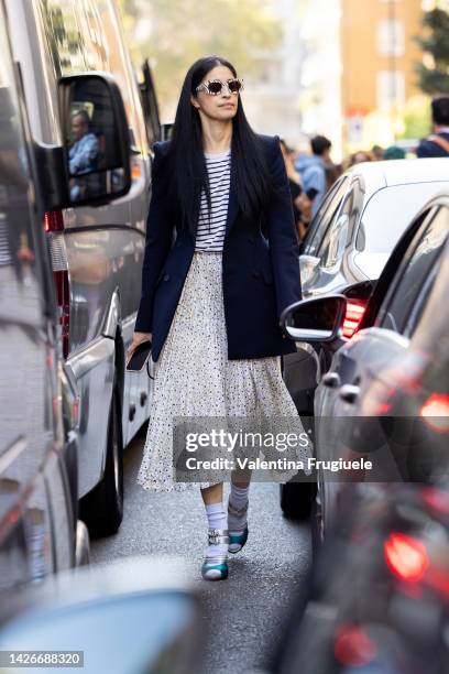 Caroline Issa is seen wearing a pleated polka dot skirt and socks over sandals at Missoni show during the Milan Fashion Week - Womenswear...