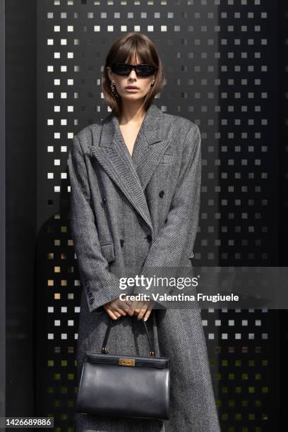 Guest is seen wearing a long grey coat at Gucci show during the Milan Fashion Week - Womenswear Spring/Summer 2023 on September 23, 2022 in Milan,...