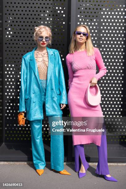 Guest is seen wearing a cobalt sparkly dress and a top made of chains and a pink dress over purple pants and a chain bra over the dress at Gucci show...