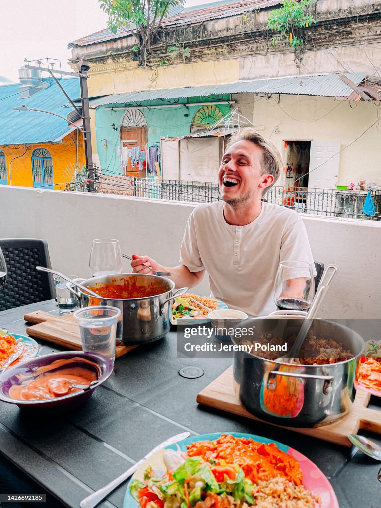 Handsome Caucasian Young Man Laughing during a Dinner Party Food Tour in Panama City, Panama