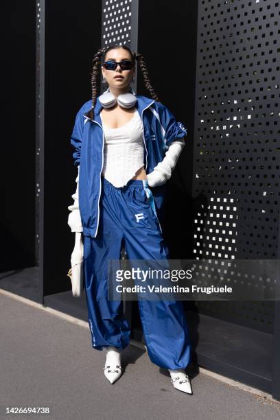 Karina Nigay is seen wearing a blue track suit, a white bodice and braids at Gucci show during the Milan Fashion Week - Womenswear Spring/Summer 2023...