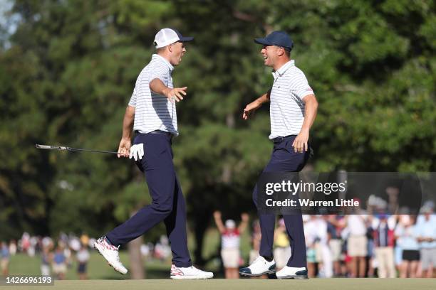 Jordan Spieth and Justin Thomas of the United States Team celebrate winning 2&1 over Adam Scott of Australia and Cam Davis of Australia and the...