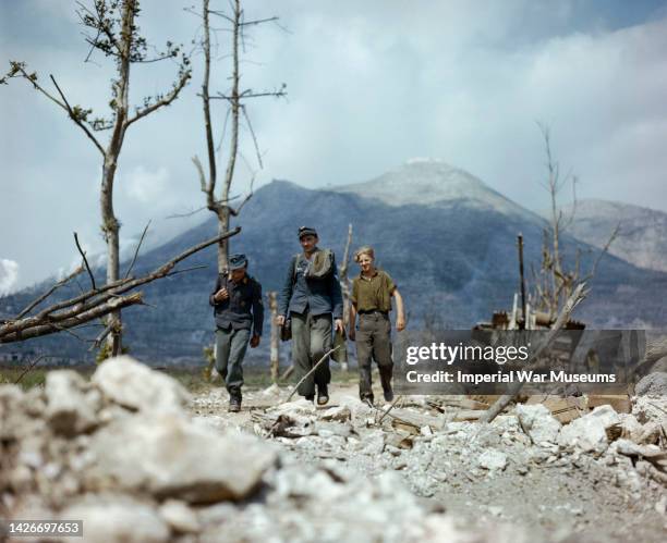Three prisoners of the German Wehrmacht walking along the debris on Highway 6, the route to Rome from Cassino, 1944.