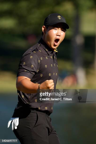 Tom Kim of South Korea and the International Team reacts on the 14th green after putting to extend the match during Friday four-ball matches on day...