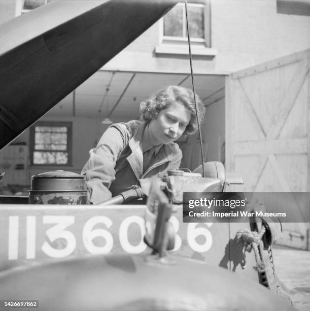 Princess Elizabeth taking out the plugs of a car at the Auxiliary Territorial Service Training Centre, Aldershot, Surrey 1945.