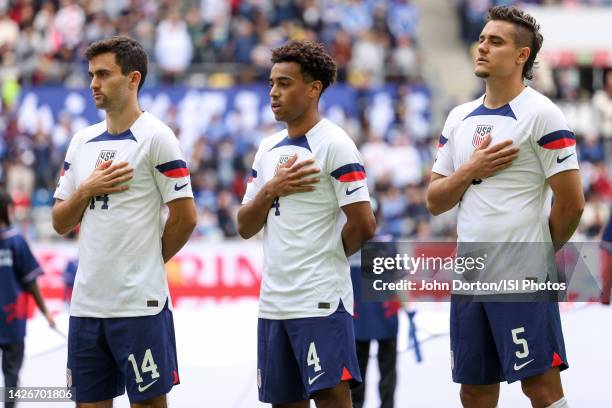 Luca de la Torre, Tyler Adams and Aaron Long of the United States during the National anthem before a game between Japan and USMNT at Düsseldorf...