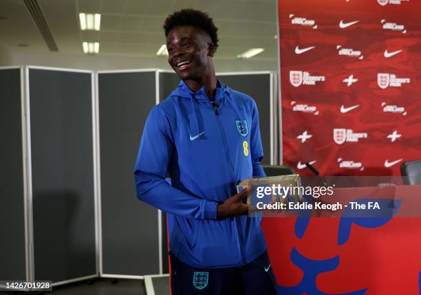 Bukayo Saka of England is presented with the Player of the Year award during the Press Conference at the England Nations League Camp at St George's...