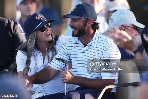 Max Homa of the United States Team and wife Lacey Croom leave the 18th green in a golf cart during Friday four-ball matches on day two of the 2022...