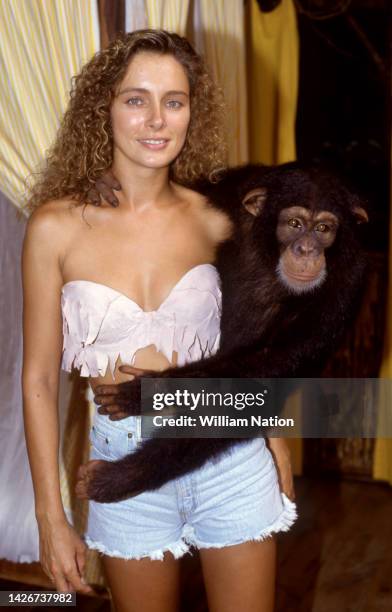 French-American model and actress Lydie Denier, poses with a chimpanzee on the set of the TV series Tarzan in Puerto Escondido, Mexico in August...