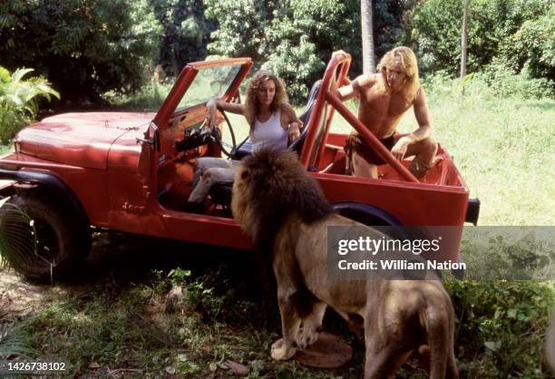 French-American model and actress Lydie Denier and German-Canadian actor, screenwriter, and producer Wolf Larson, sit in a jeep on the set of the TV...