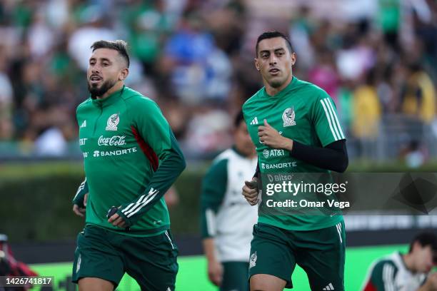 Hector Herrera and Rogelio Funes Mori of Mexico warm up during a training session ahead of a match between Mexico and Peru at Rose Bowl Stadium on...