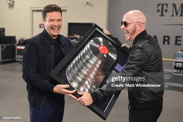 Ryan Seacrest and Pitbull pose with an award during the 2022 iHeartRadio Music Festival at T-Mobile Arena on September 23, 2022 in Las Vegas, Nevada.