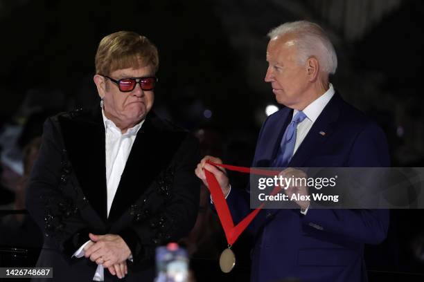 President Joe Biden presents British singer-songwriter Sir Elton John with the National Humanities Medal during an event on the South Lawn of the...