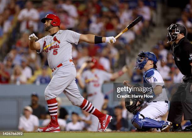 Albert Pujols of the St. Louis Cardinals watches career homerun 699 with Will Smith of the Los Angeles Dodgers, to take a 2-0 lead, during the third...