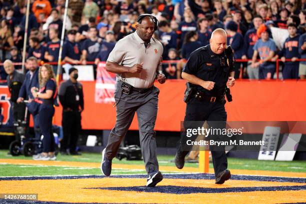 Head Coach Dino Babers of the Syracuse Orange runs off the field at the end of the third quarter against the Virginia Cavaliers at JMA Wireless Dome...