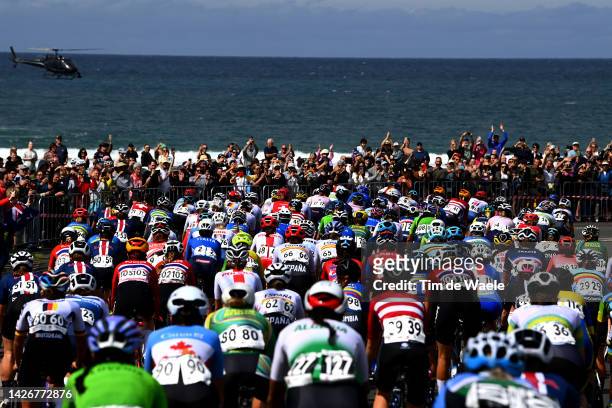 General view of the peloton compete passing through Bulli village while fans cheer during the 95th UCI Road World Championships 2022 - Women Elite...
