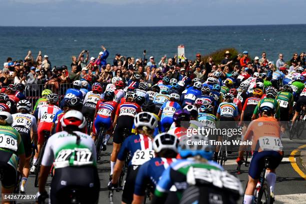 General view of the peloton compete passing through Bulli village while fans cheer during the 95th UCI Road World Championships 2022 - Women Elite...