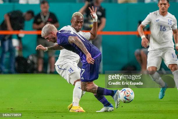Midfielder Rodrigo De Paul of Argentina kicks the ball while being defended by Midfielder Deybi Aldair Flores Flores of Honduras during the...