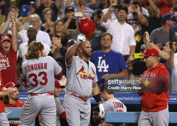 Albert Pujols of the St. Louis Cardinals tips his hat to fans after hitting his 700th career homerun, his second homerun of the game, to take a 5-0...
