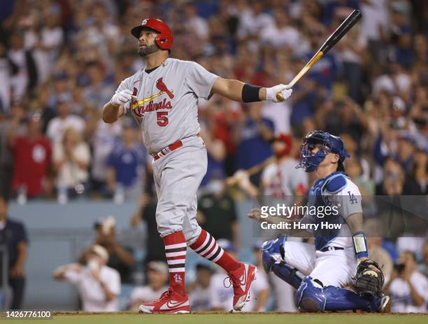 Albert Pujols of the St. Louis Cardinals watches his 700th career homerun with Will Smith of the Los Angeles Dodgers, a three run homerun to take a...