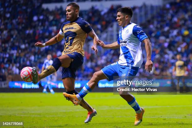 Nicolas Freire of Pumas battles for possession with Martin Barragan of Puebla during the 7th round match between Puebla and Pumas UNAM as part of the...