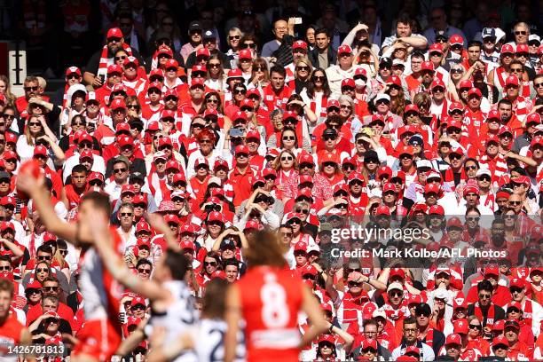 Swans supporters in the crowd watch on during the 2022 AFL Grand Final match between the Geelong Cats and the Sydney Swans at the Melbourne Cricket...