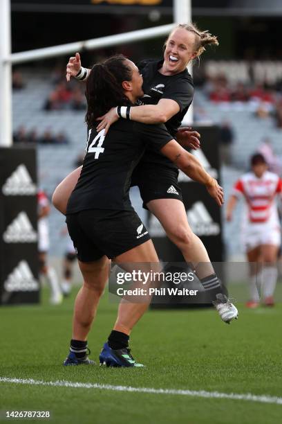 Portia Woodman of the Black Ferns is congratulated on her hat trick try by Kendra Cocksedge during the International Women's test match between the...