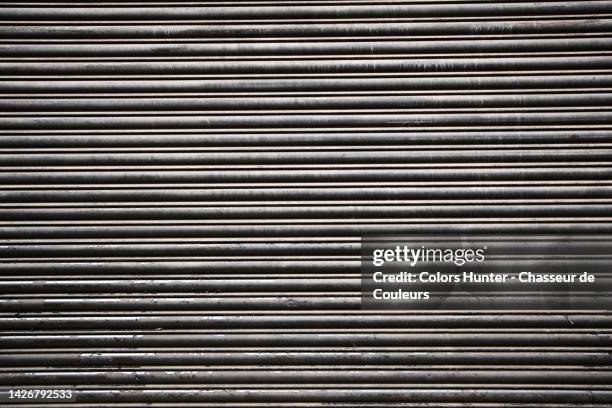 very close-up of a weathered metal roller shutter in london, england, uk - よろい戸 ストックフォトと画像