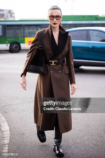 Mary Leest is seen wearing a brown long coat with fur details and a fur brown Tod's bag outside the Tod's show during the Milan Fashion Week -...