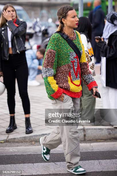 Guest is seen wearing a multicolor JW Anderson sweater outside the Tod's show during the Milan Fashion Week - Womenswear Spring/Summer 2023 on...