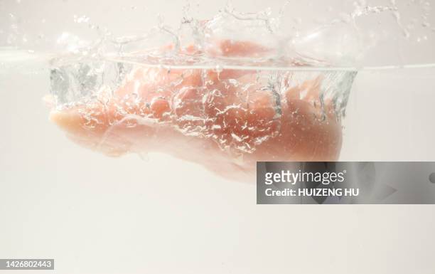 raw chicken breast falling into the water with splash - pepper spray stockfoto's en -beelden