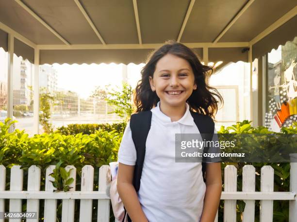 portrait of a young student girl smiling outside the school - only girls stock pictures, royalty-free photos & images
