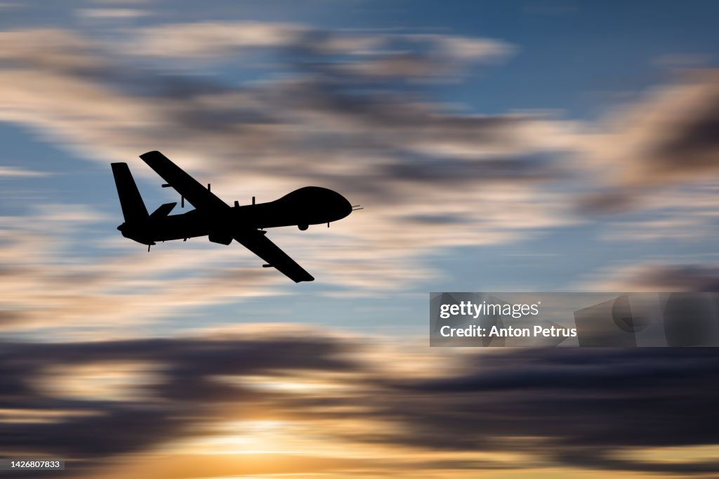 Military unmanned aerial vehicle at sunset. Combat drone in military conflicts
