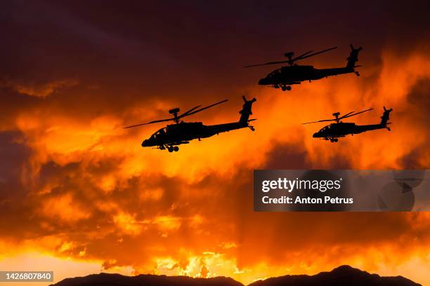 military helicopters against the background of the sunset sky - air raid stock pictures, royalty-free photos & images