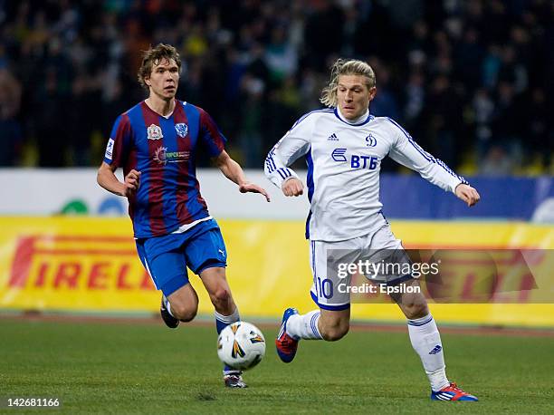 Andriy Voronin of FC Dynamo Moscow battles for the ball with Nikita Chicherin of FC Volga Nizhny Novgorod during the Russian Cup Semi Final match...