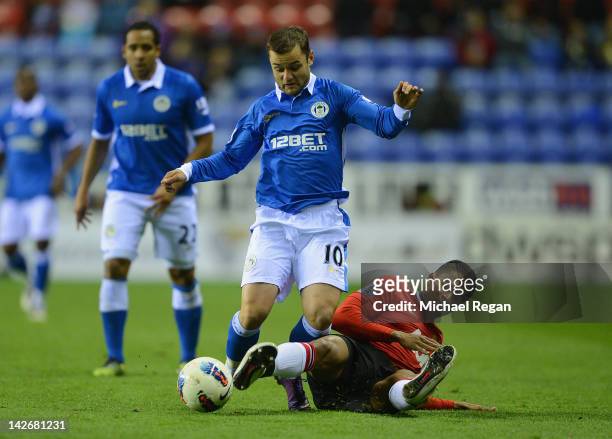 Shaun Maloney of Wigan battles Antonio Valencia of Man Utd during the Barclays Premier League match between Wigan Athletic and Manchester United at...