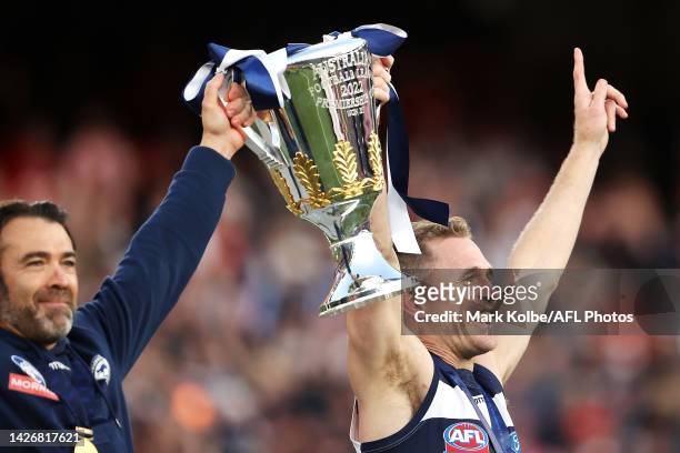 Geelong Cats head coach Chris Scott and Joel Selwood of the Geelong Cats celebrate with the trophy as they celebrate victory during the 2022 AFL...