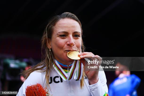 Gold medalist and world champion winner Annemiek Van Vleuten of Netherlands, kiss at her trophy on the podium during the medal ceremony after the...
