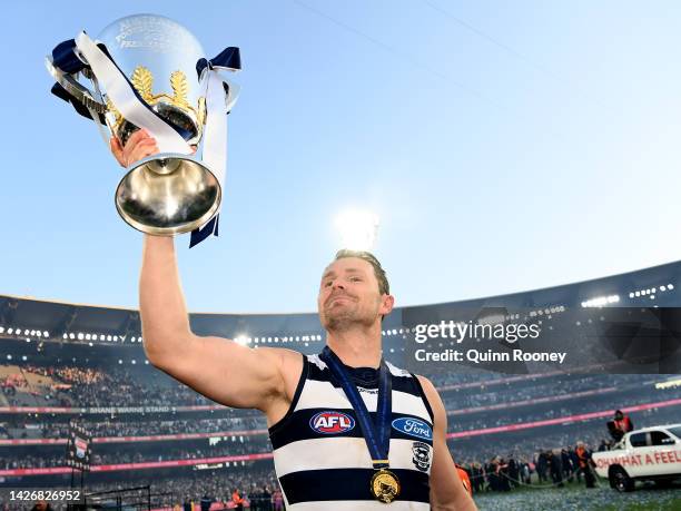 Patrick Dangerfield of the Cats celebrates with the premiership trophy after winning the 2022 AFL Grand Final match between the Geelong Cats and the...