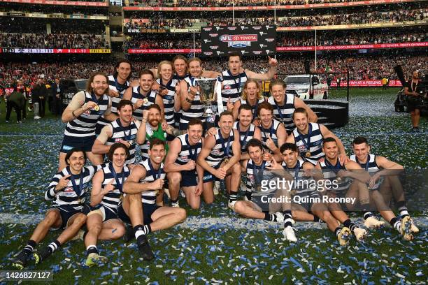 The Geelong Cats pose with the premiership trophy after winning the 2022 AFL Grand Final match between the Geelong Cats and the Sydney Swans at the...