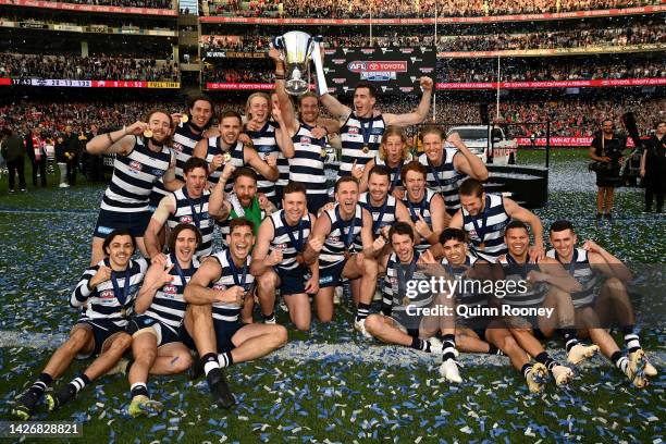 The Geelong Cats pose with the premiership trophy after winning the 2022 AFL Grand Final match between the Geelong Cats and the Sydney Swans at the...