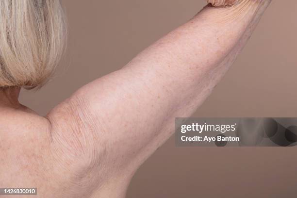 close-up of senior woman's bare shoulder - old skin stockfoto's en -beelden