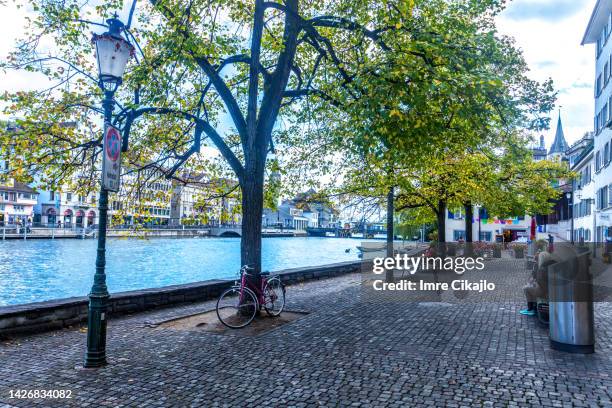 lazy afternoon at limmat river waterfront in zurich old town - zurich cafe stock pictures, royalty-free photos & images