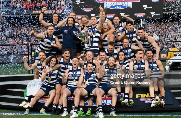 The Cats pose with the premiership cup after winning the 2022 AFL Grand Final match between the Geelong Cats and the Sydney Swans at the Melbourne...