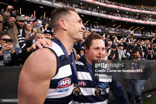 Joel Selwood of the Cats celebrates with Cats head waterboy Sam Moorfoot after winning the 2022 AFL Grand Final match between the Geelong Cats and...