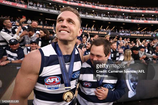 Joel Selwood of the Cats celebrates with Cats head waterboy Sam Moorfoot after winning the 2022 AFL Grand Final match between the Geelong Cats and...