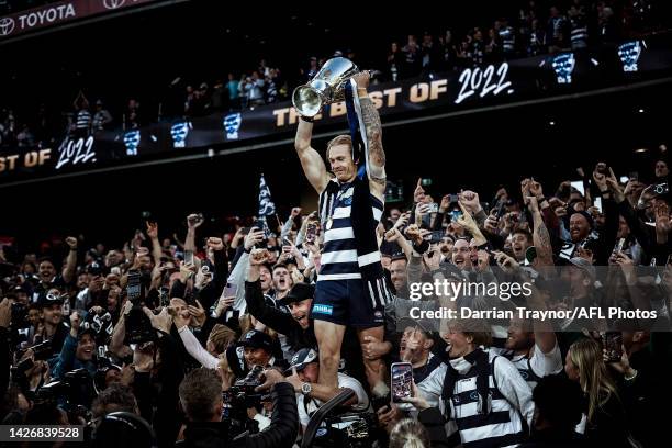 Tom Stewart of the Cats celebrates with the Premiership Cup after the 2022 AFL Grand Final match between the Geelong Cats and the Sydney Swans at the...