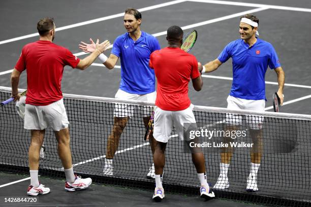 Frances Tiafoe and Jack Sock of Team World embrace Roger Federer and Rafael Nadal of Team Europe after their doubles match during Day One of the...