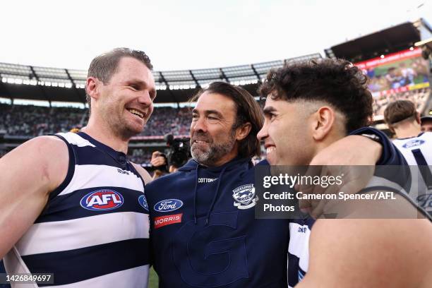 Patrick Dangerfield of the Cats and Tyson Stengle of the Cats celebrate with Cats head coach Chris Scott after winning the 2022 AFL Grand Final match...