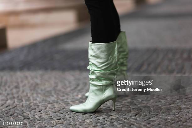Veronika Heilbrunner is seen wearing black long dress from Skims and green metallic Toras high boots, on September 20, 2022 in Munich, Germany.